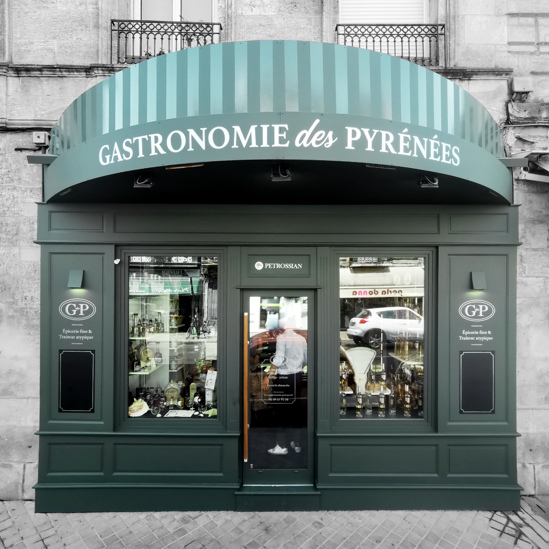 Boutique Gastronomie des Pyrénées verte avec lettrage blanc sur la devanture